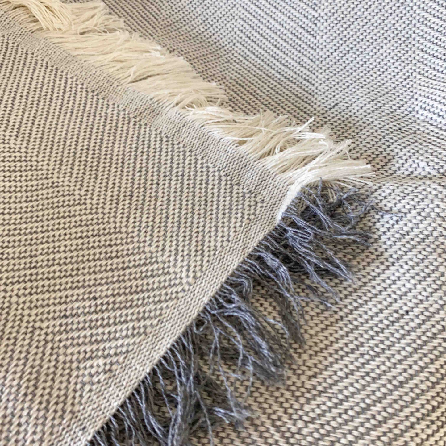 Multipurpose summer quilt for sofa or bed. Light gray color.
