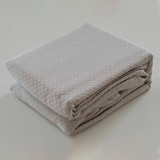 Geometric patchwork quilt with thin padding. Beige.