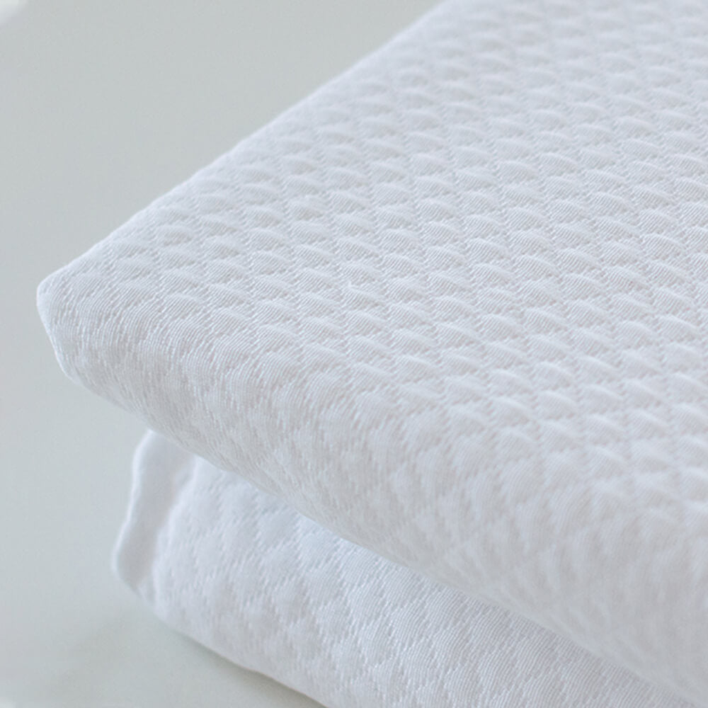 Geometric patchwork quilt with thin padding. Beige.
