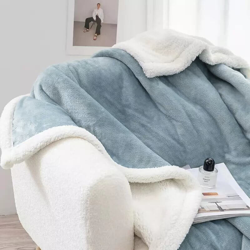 Extra soft reversible shearling blanket with border. Color blue.